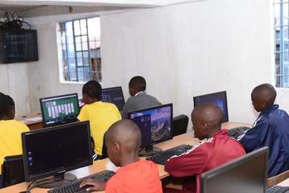 Learners working at desktop computers in the computer lab.