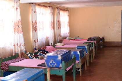 A boarding dormitory with rows of beds.