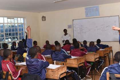 A learner raising their hand during a lesson.