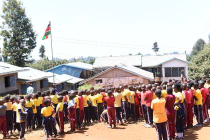Learners standing together during a school assembly.