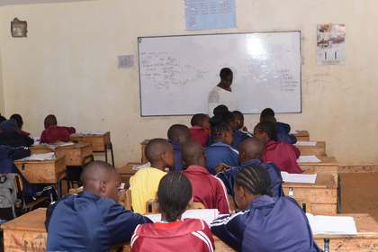 Learners seated at their desks during a lesson.