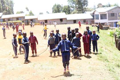 Learners playing together on the school field.