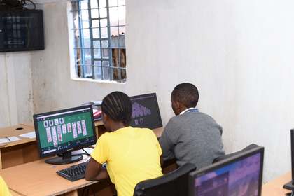 Learners seated at computers in the computer lab.