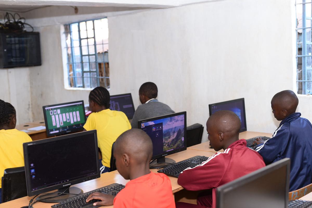 Learners working at desktop computers in the computer lab.
